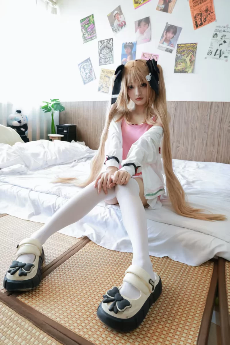 a woman in satin pajamas has her feet tickled